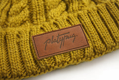 Leather patch close up on Mustard twist Knitted Beanie platypus hat independent streetwear fashion