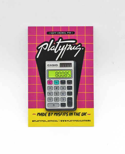 Nostalgic Glow in the Dark Boobs Casio Calculator Enamel Pin badge in packaging | Designer Maxine Abbott