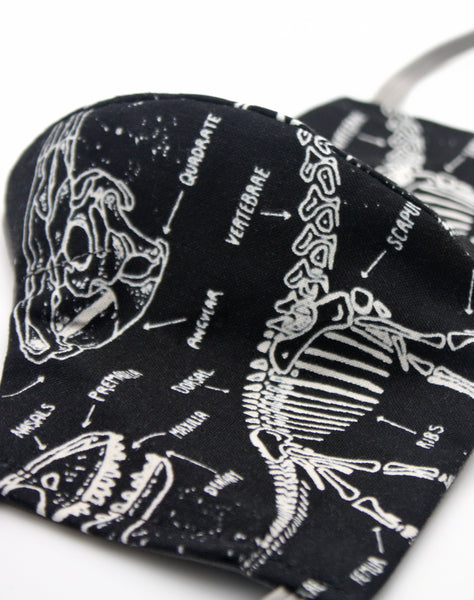 Close up of glow in the dark dino bones pattern handmade face covering uk