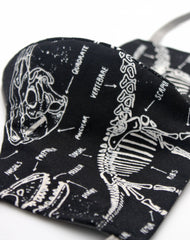 Close up of glow in the dark dino bones pattern handmade face covering uk