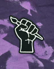  Platypus UK's Art Revolution Black Fist Graphic Iron-on Patch Design by Maxine Abbott on purple acid wash