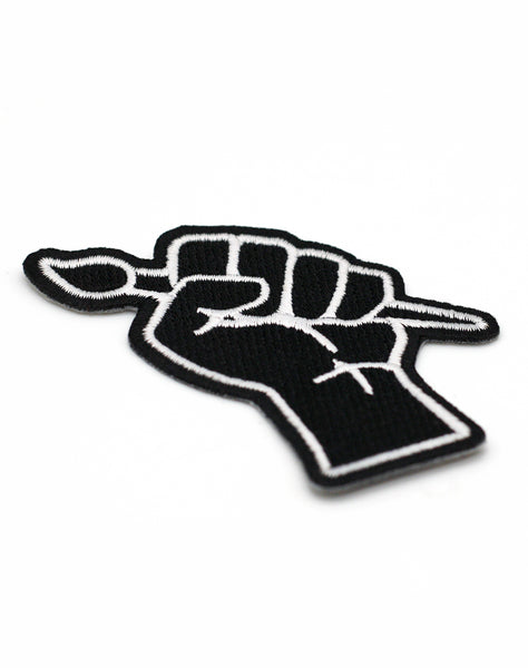 Close up of protest art black power fist punk embroidered iron-on patch Platypus UK Streetwear