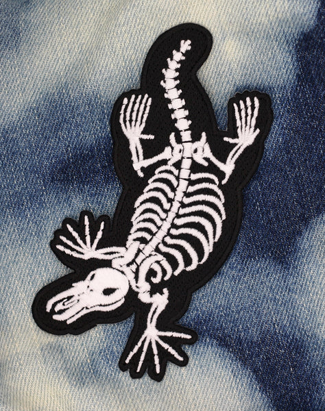 creepy cute artist art platypus skeleton spooky gothic alternative patch design on bleached denim jacket 
