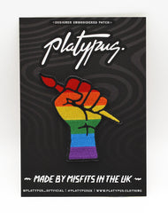 Queer protest art raised fist badge lgbtq gay rainbow pride iron-on patch badge by Maxine Abbott | Platypus UK Nottingham